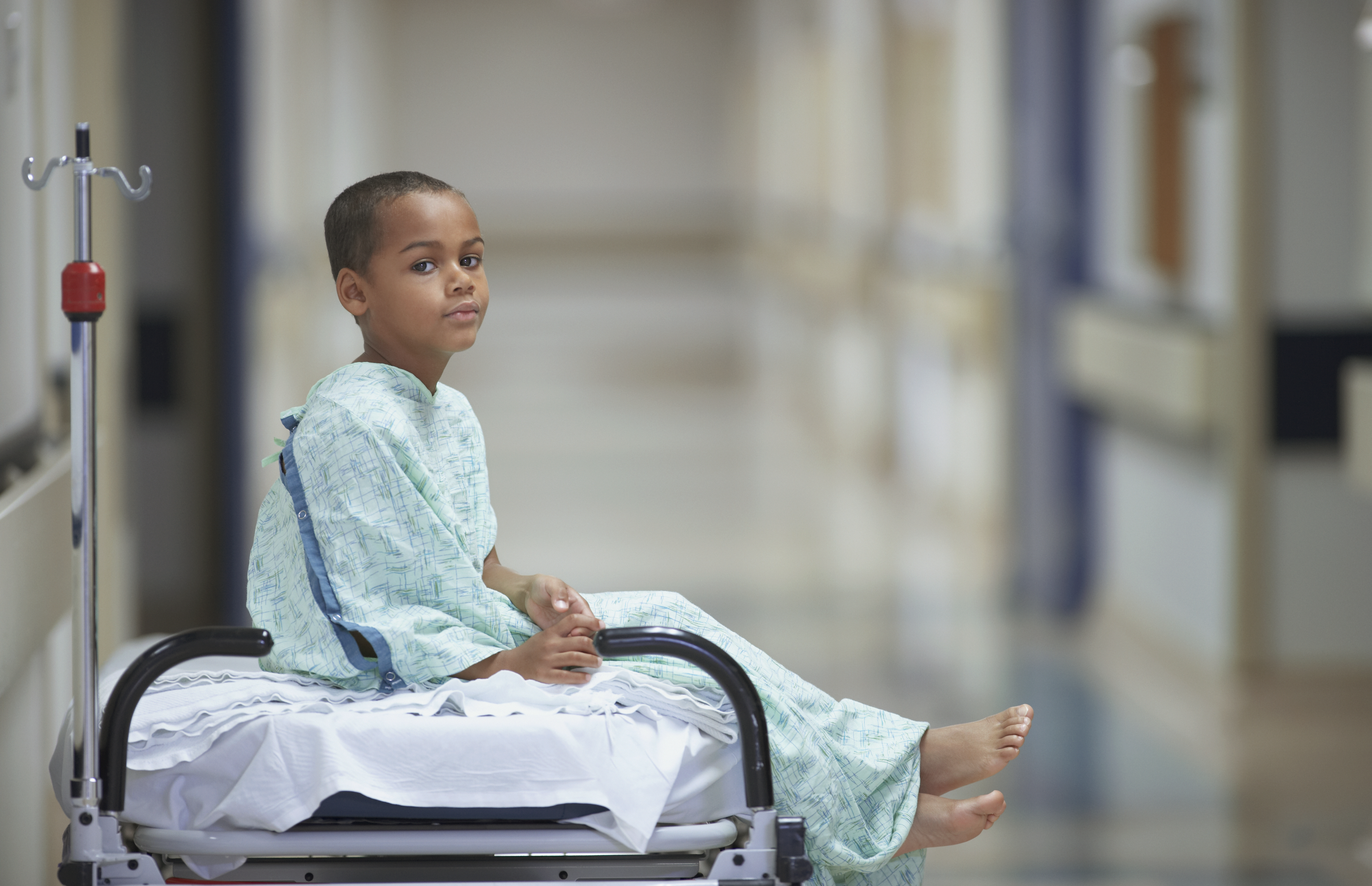 Mixed Race boy in hospital gown