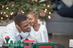 Little Girl Giving Her Father a Kiss