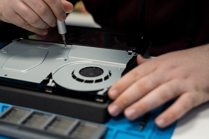 Man fixing gaming console