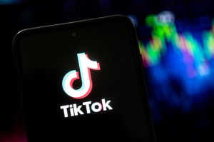 In this photo illustration a TikTok logo seen displayed on a...
