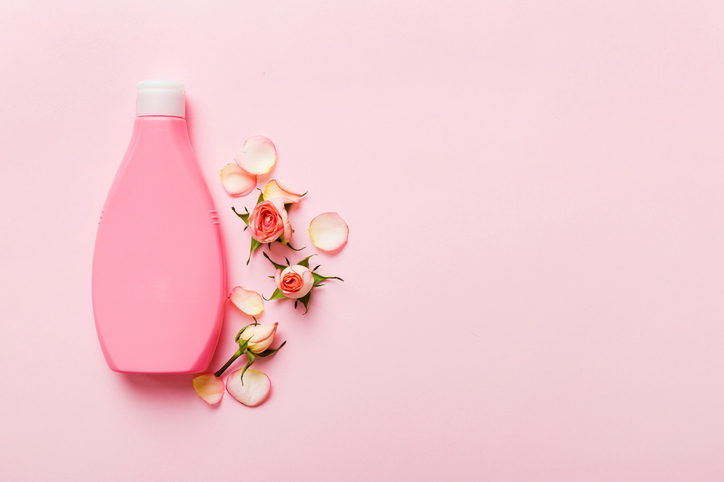 Fancy healthcare bottles for cream with rose flower. Natural oranic spa cosmetics concept. Mockup, template, Top view